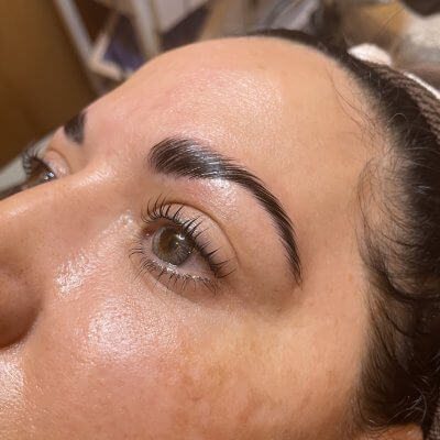 Close up image of a woman after a brow henna appointment